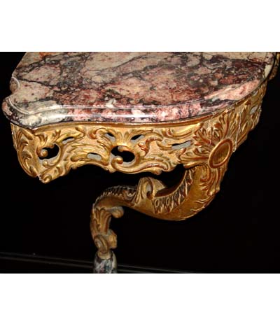 Pair of Louis XV period, carved giltwood corner consoles