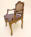 Pair of French, Regence style, carved giltwood and caned fauteuils