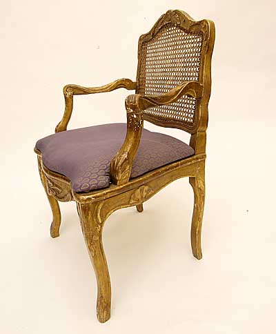 Pair of French, Regence style, carved giltwood and caned fauteuils