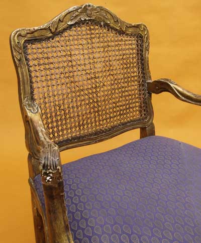 Pair of French, Regence style, carved giltwood and caned fauteuils