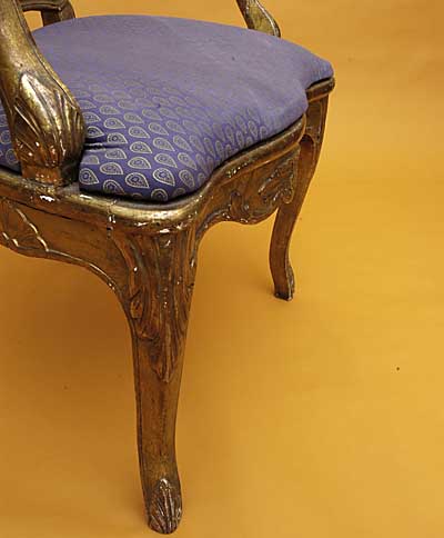 Pair of French, Regence style, carved giltwood and caned fauteuils