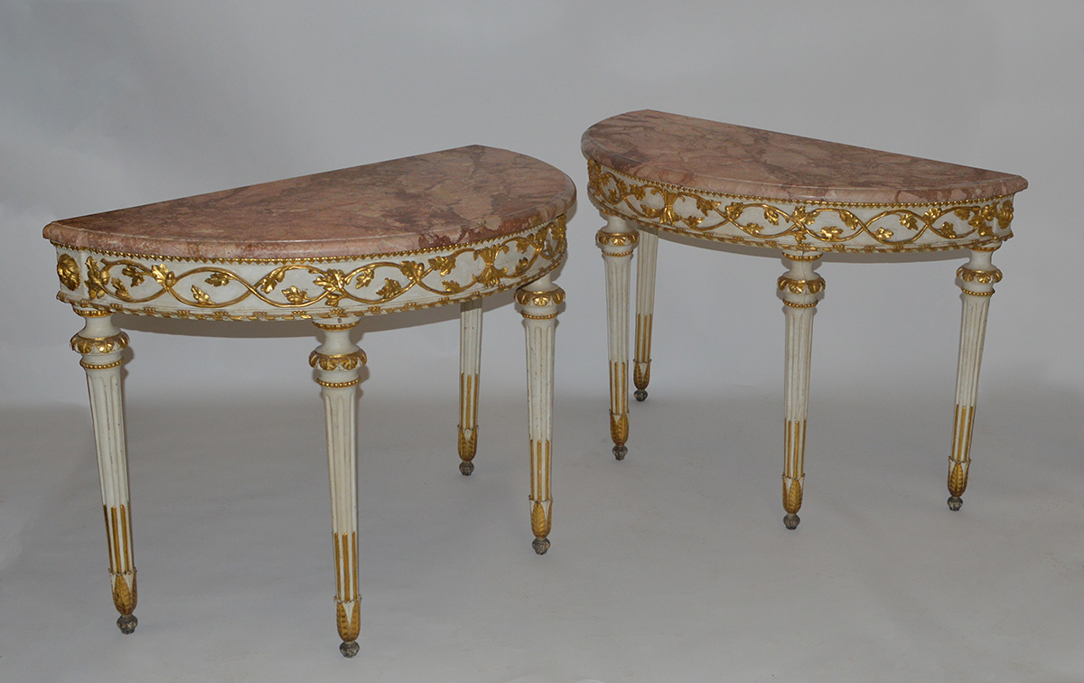 Pair of Italian, Neoclassical, white-painted and parcel-gilt demi-lune console tables