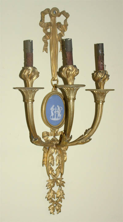 Pair of Napoleon III period (Neoclassical style), gilt bronze and porcelain three arm sconces