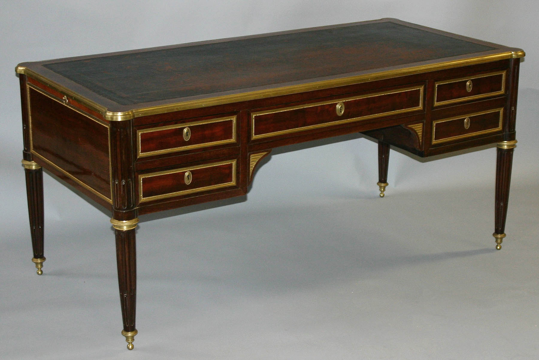 Very fine French, Neoclassical style, brass-mounted bureau plat